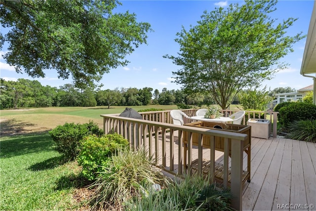 wooden terrace with a lawn