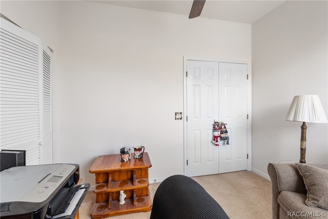 office area featuring light carpet and ceiling fan