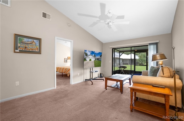 carpeted living room with ceiling fan and high vaulted ceiling