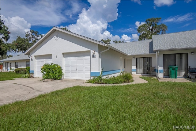 ranch-style house featuring a garage and a front yard