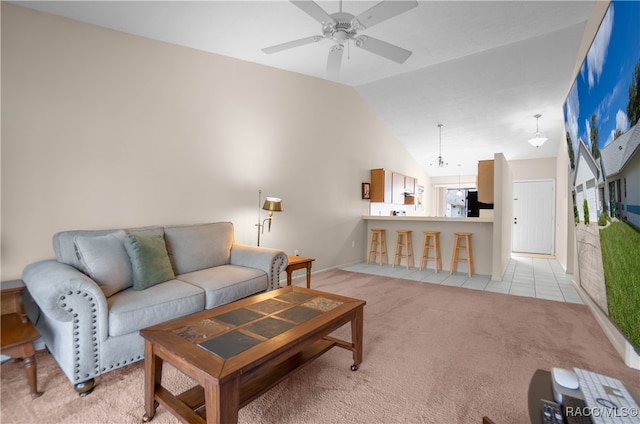 carpeted living room with ceiling fan and lofted ceiling