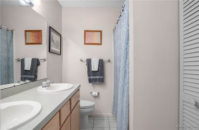 bathroom featuring tile patterned flooring, vanity, and toilet