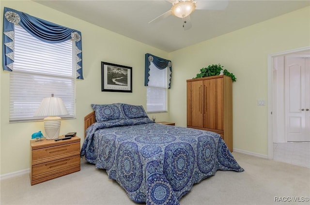bedroom featuring baseboards, carpet flooring, and a ceiling fan