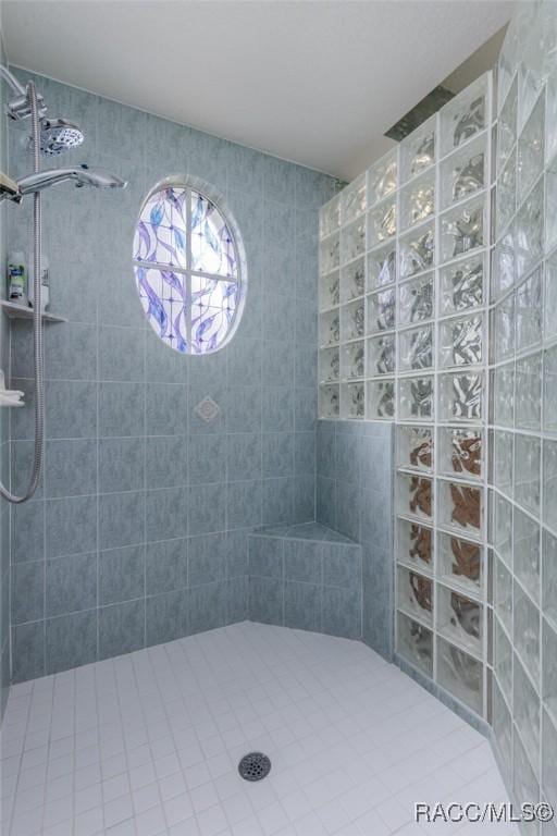 bathroom with tile patterned floors and a walk in shower