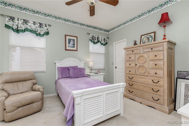 bedroom featuring light carpet and a ceiling fan