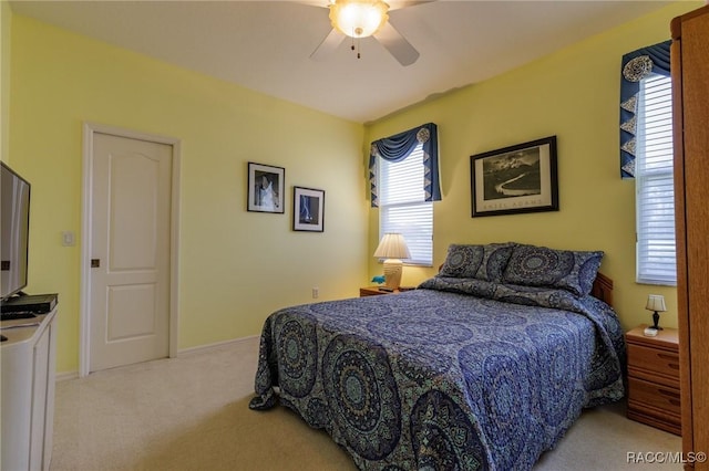 carpeted bedroom featuring ceiling fan and baseboards