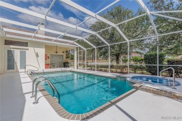 view of pool featuring a pool with connected hot tub, ceiling fan, a patio, and french doors