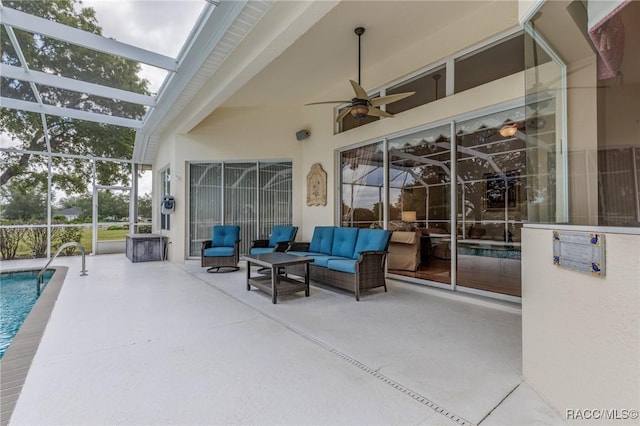 view of patio with an outdoor living space, glass enclosure, an outdoor pool, and a ceiling fan