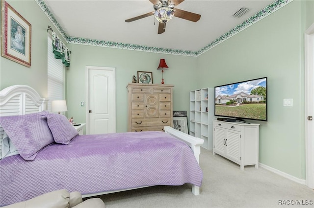 bedroom featuring ceiling fan, light carpet, baseboards, and visible vents