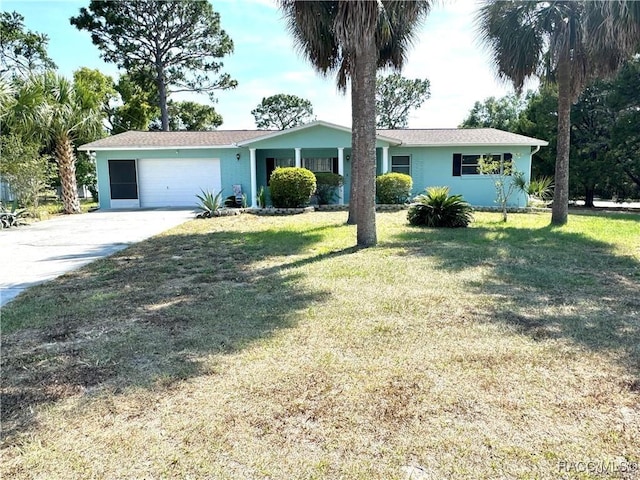 ranch-style house featuring a garage and a front yard