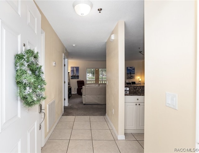 corridor featuring light tile patterned floors