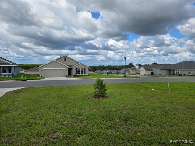 348 W Rexford Dr, Beverly Hills, FL 34465 - view of green lawn with driveway, an attached garage, and a residential view
