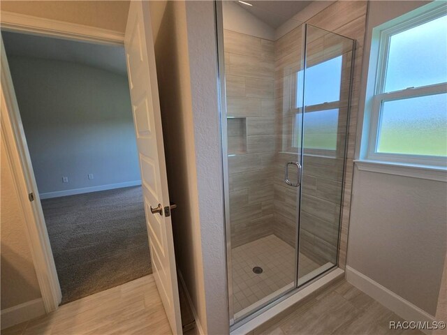 348 W Rexford Dr, Beverly Hills, FL 34465 - full bath featuring a stall shower, lofted ceiling, and wood finished floors