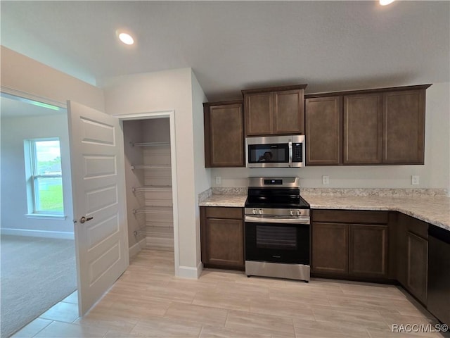 348 W Rexford Dr, Beverly Hills, FL 34465 - kitchen with stainless steel appliances, dark brown cabinetry, and recessed lighting