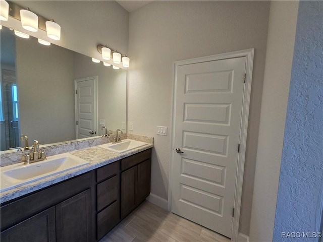 348 W Rexford Dr, Beverly Hills, FL 34465 - bathroom featuring double vanity and wood finished floors