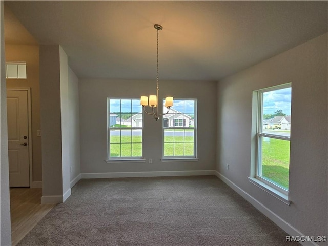 348 W Rexford Dr, Beverly Hills, FL 34465 - unfurnished dining area with healthy amount of natural light, a chandelier, and carpet flooring