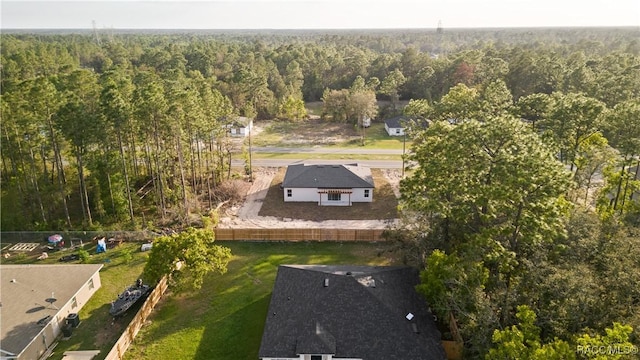 drone / aerial view with a wooded view