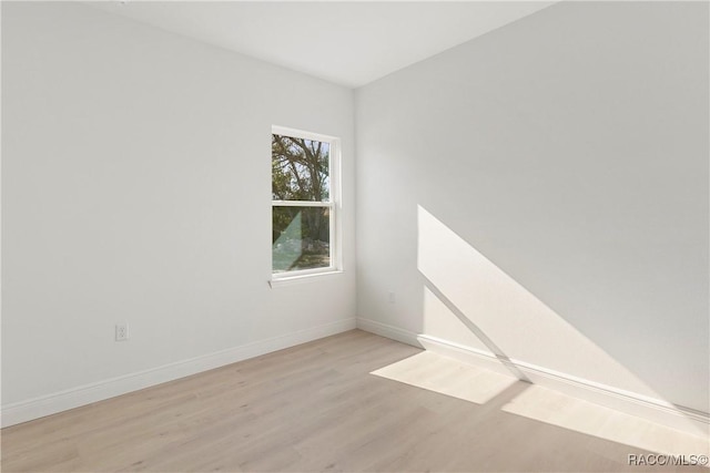 unfurnished room with wood finished floors and baseboards