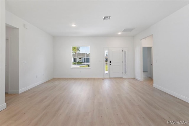 unfurnished living room featuring baseboards, visible vents, light wood-style floors, and recessed lighting