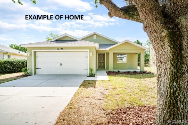 view of front of property with a garage and a front yard