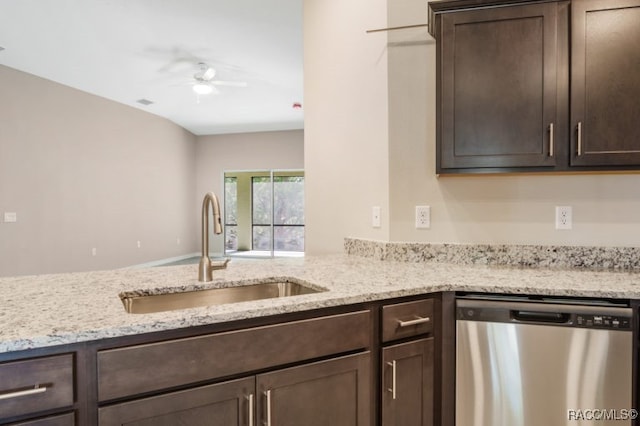 kitchen featuring dishwasher, dark brown cabinets, light stone countertops, and sink