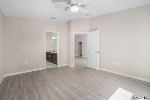 unfurnished room with ceiling fan, light hardwood / wood-style floors, and vaulted ceiling