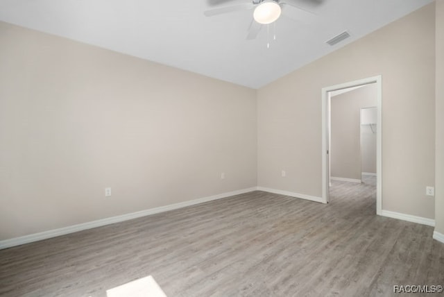 unfurnished room with vaulted ceiling, light hardwood / wood-style flooring, and ceiling fan