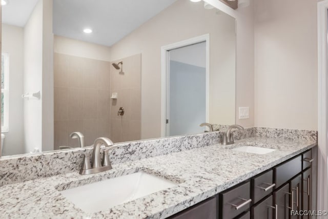 bathroom featuring vanity and a tile shower