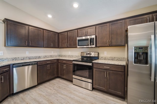 kitchen featuring light hardwood / wood-style floors, dark brown cabinetry, stainless steel appliances, and vaulted ceiling