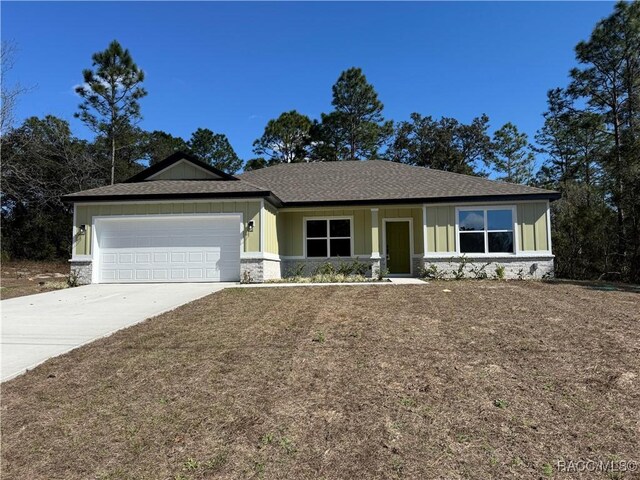 view of front of home with a garage and a front yard