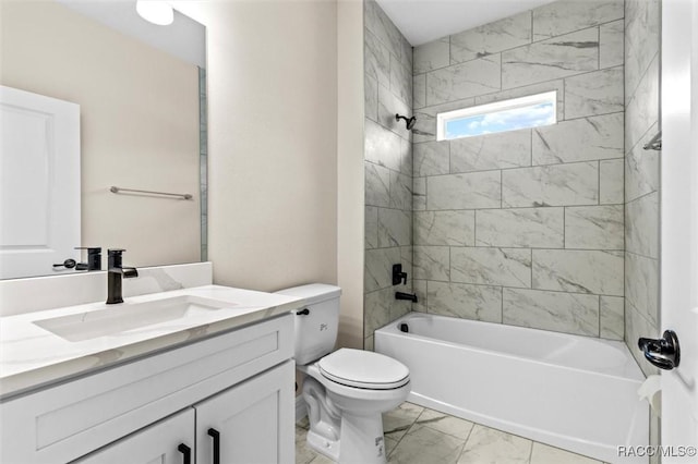 full bathroom featuring vanity, tiled shower / bath, and toilet