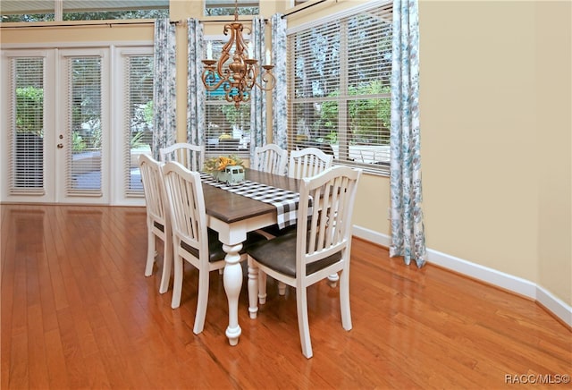 dining room with an inviting chandelier and hardwood / wood-style flooring