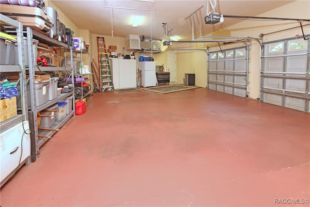 garage featuring white fridge and a garage door opener