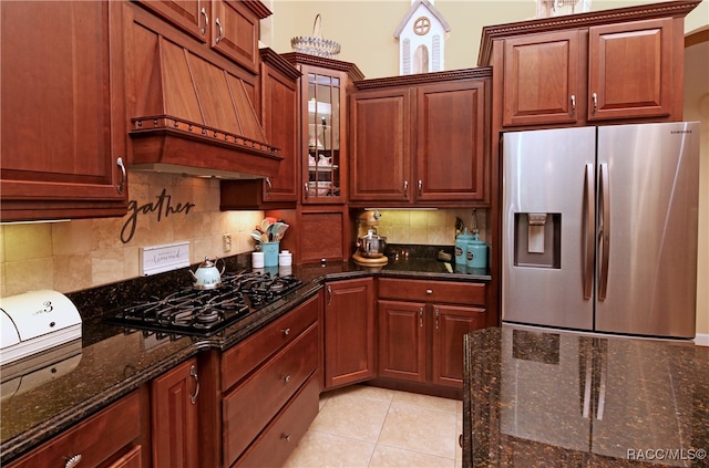 kitchen featuring tasteful backsplash, premium range hood, black gas cooktop, stainless steel fridge with ice dispenser, and light tile patterned flooring