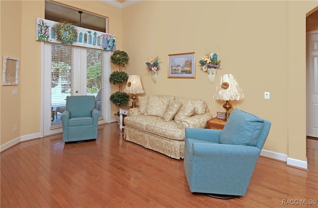 living room with hardwood / wood-style floors and crown molding