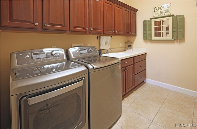 laundry room with separate washer and dryer, sink, light tile patterned floors, and cabinets