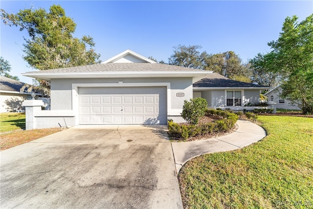 ranch-style home with a garage and a front lawn