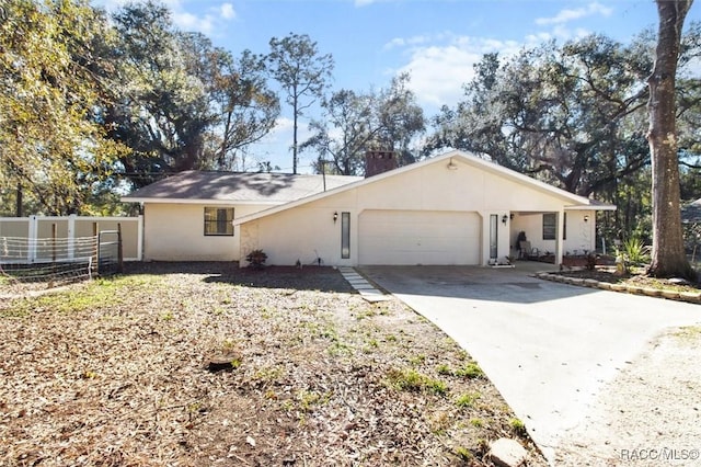 ranch-style house with a garage, driveway, a chimney, fence, and stucco siding