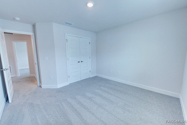 unfurnished bedroom with carpet and a closet