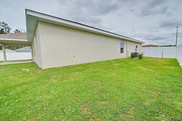 rear view of house featuring a yard and cooling unit