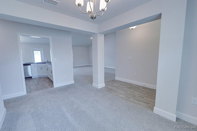 8330 N India Way, Citrus Springs, FL 34434 - empty room with a chandelier, light colored carpet, baseboards, and a sink