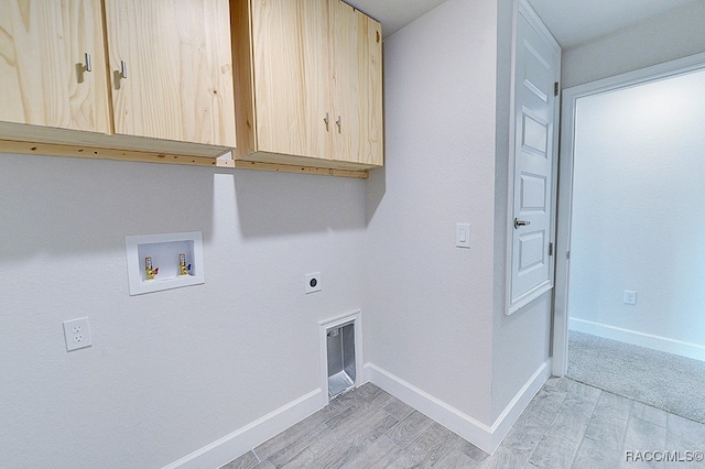 washroom with cabinets, washer hookup, light hardwood / wood-style flooring, and electric dryer hookup