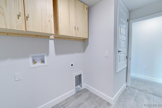 8330 N India Way, Citrus Springs, FL 34434 - laundry room with cabinet space, hookup for an electric dryer, light wood-type flooring, and hookup for a washing machine