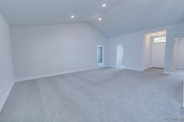 interior space featuring light carpet and vaulted ceiling