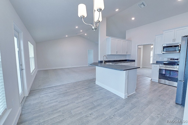 kitchen featuring white cabinetry, sink, pendant lighting, and appliances with stainless steel finishes