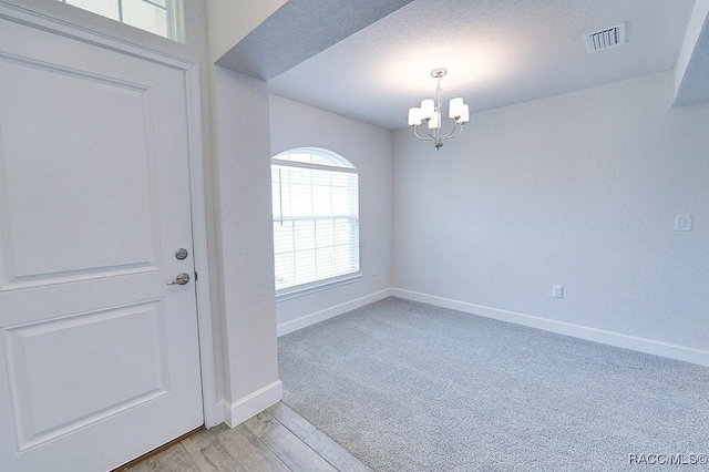 8330 N India Way, Citrus Springs, FL 34434 - foyer entrance with a chandelier, baseboards, light wood-type flooring, and light carpet