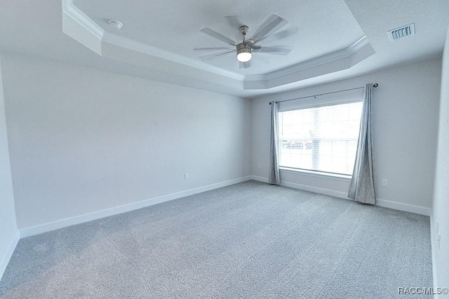 8330 N India Way, Citrus Springs, FL 34434 - spare room with a tray ceiling, crown molding, light colored carpet, ceiling fan, and baseboards