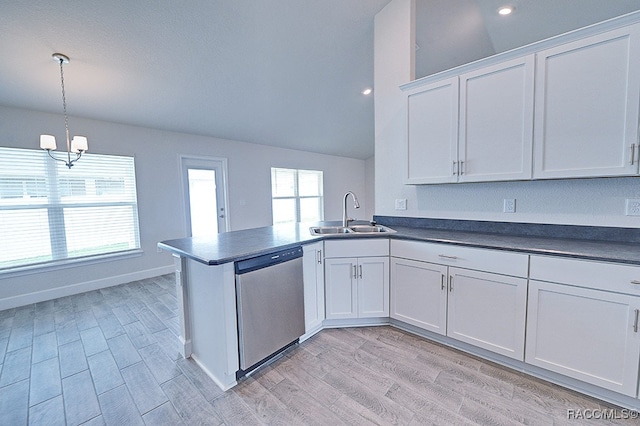 kitchen with stainless steel dishwasher, white cabinetry, sink, and vaulted ceiling