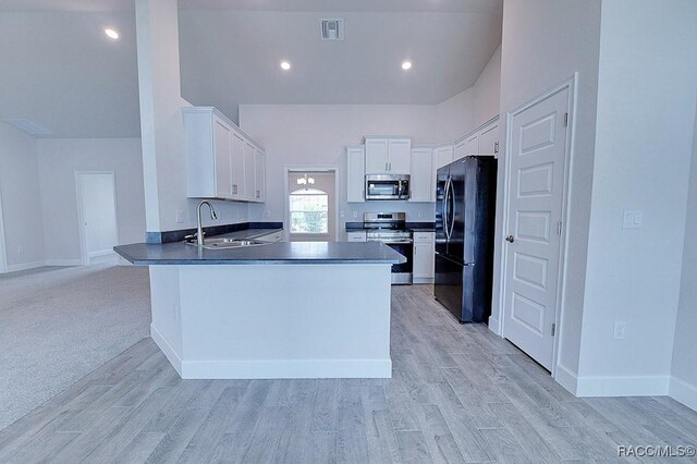 8330 N India Way, Citrus Springs, FL 34434 - kitchen featuring appliances with stainless steel finishes, a sink, a peninsula, white cabinetry, and light wood-type flooring