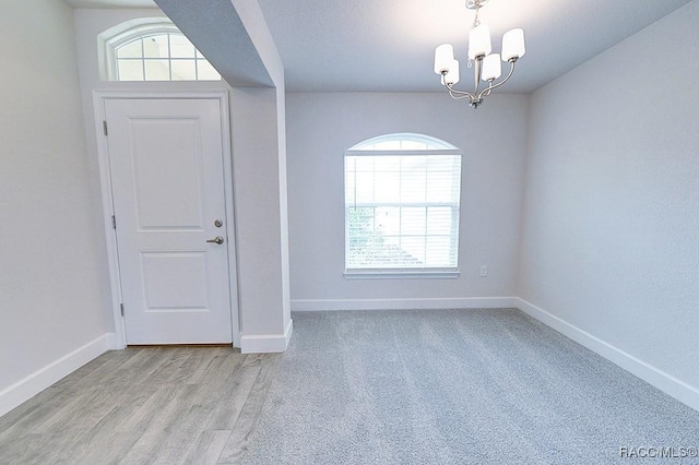 8330 N India Way, Citrus Springs, FL 34434 - unfurnished room with a chandelier, plenty of natural light, and baseboards